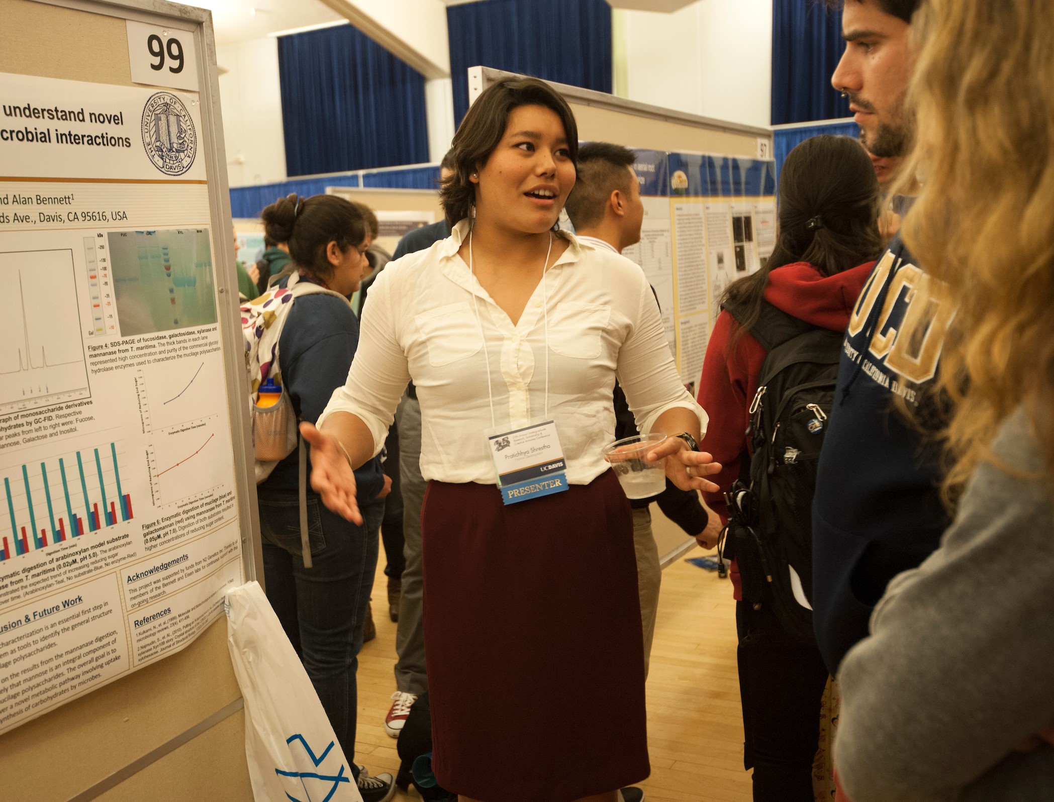 Woman talking in front of her scientific poster