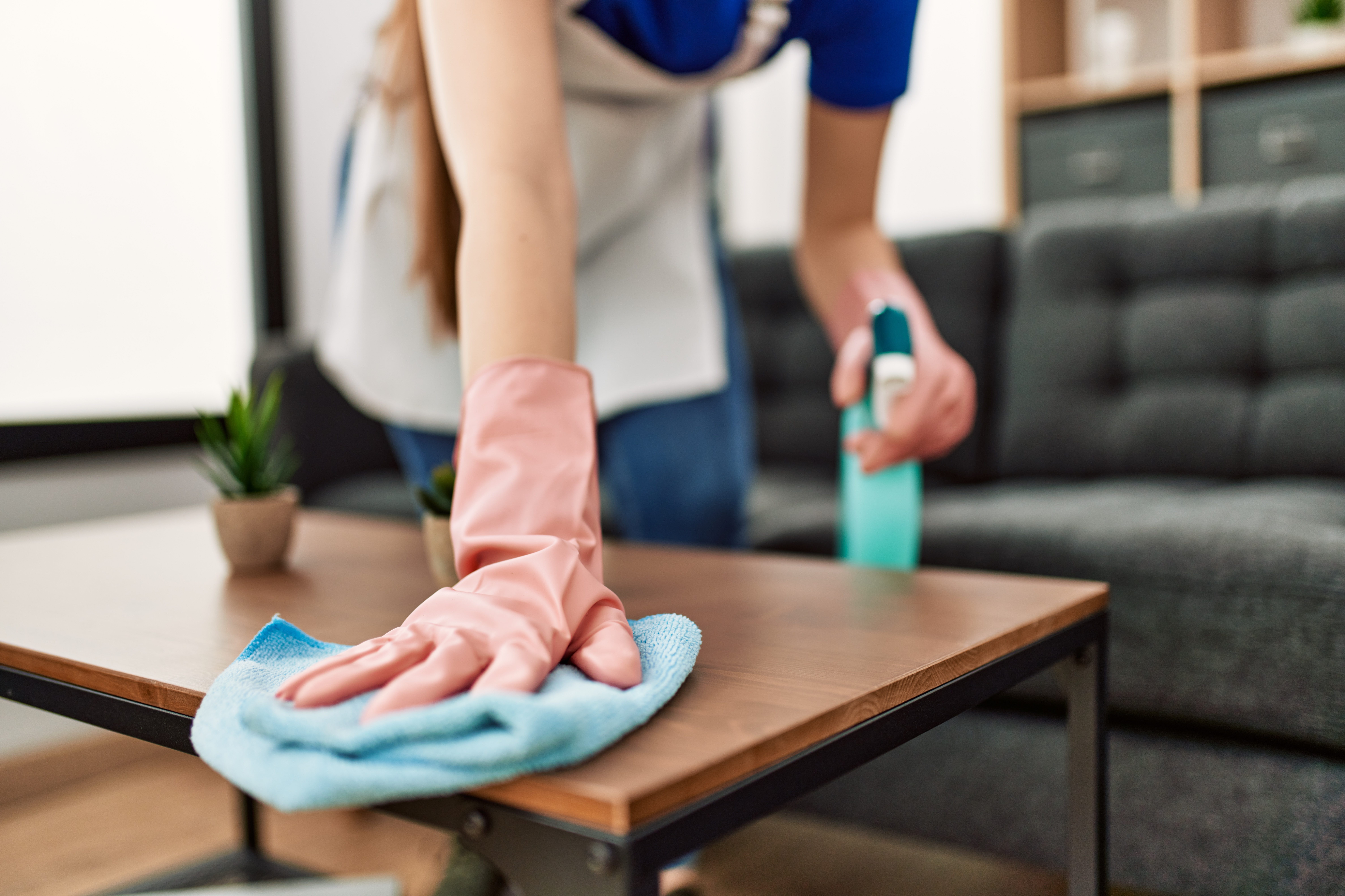 Domestic worker cleaning a table