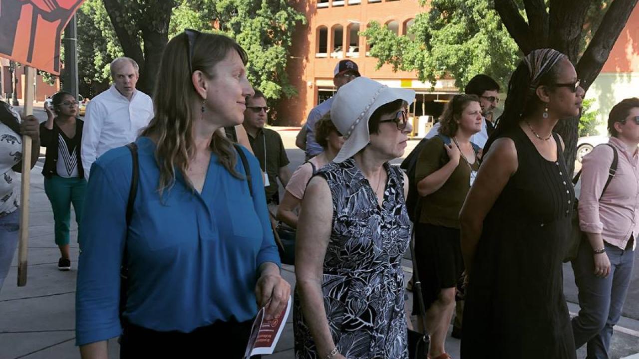 Linda Birnbaum (center), Director of the National Institute of Environmental Health Sciences, touring Fresno, CA with researchers, public health officials and community members. Scientists and community members walking