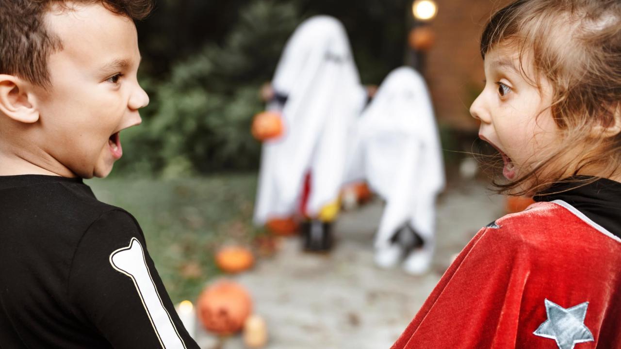 two shocked kids in costumes looking at each other