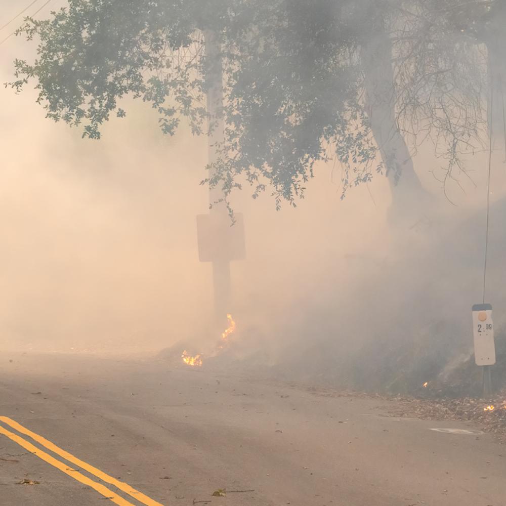 firefighter walking in wildfire smoke