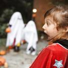 two shocked kids in costumes looking at each other