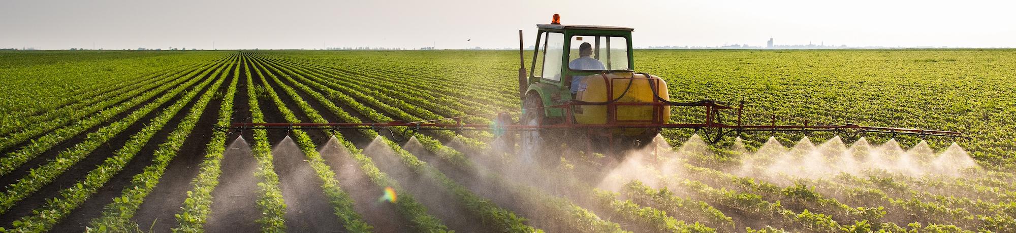 tractor spraying on field